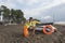 Girl lifeguard on duty keeping a buoy at the beach. Water scooter, Lifeguard rescue equipment orange preserver tool on beach. Saf