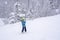 A girl lifting on the ski drag lift rope in blue sport outfit on the ski resort mountain do a ski lesson during a