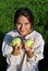 Girl in a linen shirt, holding apples