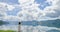 Girl listen to music standing on platform on beach