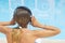 Girl listening to music by the pool