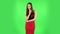 Girl listens carefully, threatens with a finger and waves her head seductively. Green screen