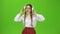 Girl listens to music on headphones . Green screen