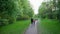 A girl and a little girl walk along the path of the Park in spring in may.