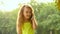 Girl little long haired talking on smartphone beautiful summer day on the background trees. Close up