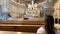 a girl with long hair in a dress sits inside the church and looks at the iconostasis Diocesan Sanctuary Viana do Castelo