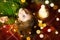 A girl with long hair and garlands lies on a red plaid under a Christmas tree with toys in a warm knitted sweater. Christmas, New