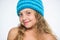 Girl long hair happy face white background. Kid wear warm soft knitted blue hat. Difference between knitting and crochet