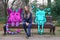 A girl with long hair is sitting and sad on a Park bench with her imaginary monster friends. Drawing on top of the photo