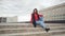 Girl with long hair sitting on steps