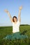 Girl in long skirt sitting on summer lawn