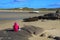 A girl look a beached wreck in Bunbeg beach