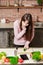 Girl look at the tablet.Young Woman Cooking in the kitchen at home. Healthy Food.