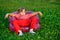 Girl looking aside in inflatable armchair