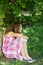 Girl Looking Away While Sitting In Park