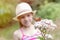 Girl looking at butterfly perching on flowers at park