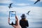 Girl looking at the calm sea on the with wind in her hair and seagulls on the background