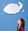 Girl looking at cartoon night clouds with moon hanging down