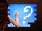 Girl looking at cloud sign in hole in brick wall