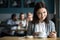 Girl looking at dessert ordered by guys flirting in cafe