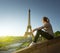 Girl looking at the Eiffel tower in sunrise time