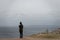 Girl looking at her phone next to the hill in sleeping bear dunes in lake Michigan