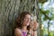 Girl Looking At Leaf Through Magnifying Glass At Park