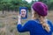 Girl looking in mirror in nature