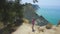 Girl looking at the sheer white cliffs of Cape Drastis near Peroulades