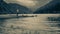 Girl is looking toward mountain and lake in the Wicklow Mountains, Glendalough Upper lake covered with mist and fog in upper part,