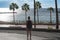 Girl is looking towards ocean in Puerto Rico. Playa de Amadores beach on Gran Canaria island in Spain near Tenerife island.