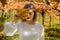 Girl looking through a vine leaf