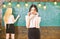 Girl looks attractive while lady writing on chalkboard background, defocused. Students and trainees concept. Student