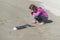 Girl looks closely at remains of fish