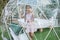Girl looks over transparent bell tent in forest, glamping, luxury travel, glamourous camping