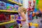 Girl looks in the window of children toy shop