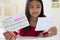 Girl Lying On Bed Using Written Study Cards To Help With Revision