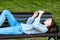 Girl is lying on bench. In summer in park nature. A schoolgirl is resting after school, of leisure in institute. He