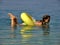 Girl lying on the toy in the sea