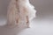 The girl in magnificent wedding dress and white sneakers, legs close-up. Runaway bride