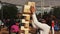 Girl make tower from wooden bricks with adult father. Summer family festival.