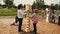Girl make tower from wooden bricks with adult man. Summer family festival.