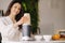 a girl makes a cocktail in a fruit blender in the kitchen. Diet for weight loss