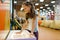 Girl makes sand picture in entertainment center