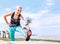 Girl makes a strching exercises on the sea embankment