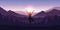 Girl makes yoga tree figure in the mountain landscape view at sunrise