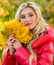 Girl makeup dreamy face hold bunch maple leaves. Lady posing with leaves autumn nature background. Autumn favorite