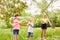 Girl making bubble by friends in summer at park