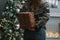 Girl making christmas surprise - holding gift behind a back