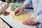 Girl making cookies in the shape of a heart in the kitchen, close-up. A woman cuts out cookies for Valentine`s day, Father`s day